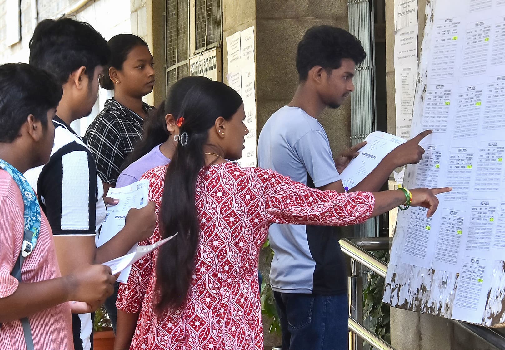 Bengaluru: Students check for their sitting arrangement before appearing for the National Eligibility cum Entrance Test (NEET-UG) at RC College in Bengaluru district of Karnataka on Sunday, June 21, 2026. (Photo: IANS)