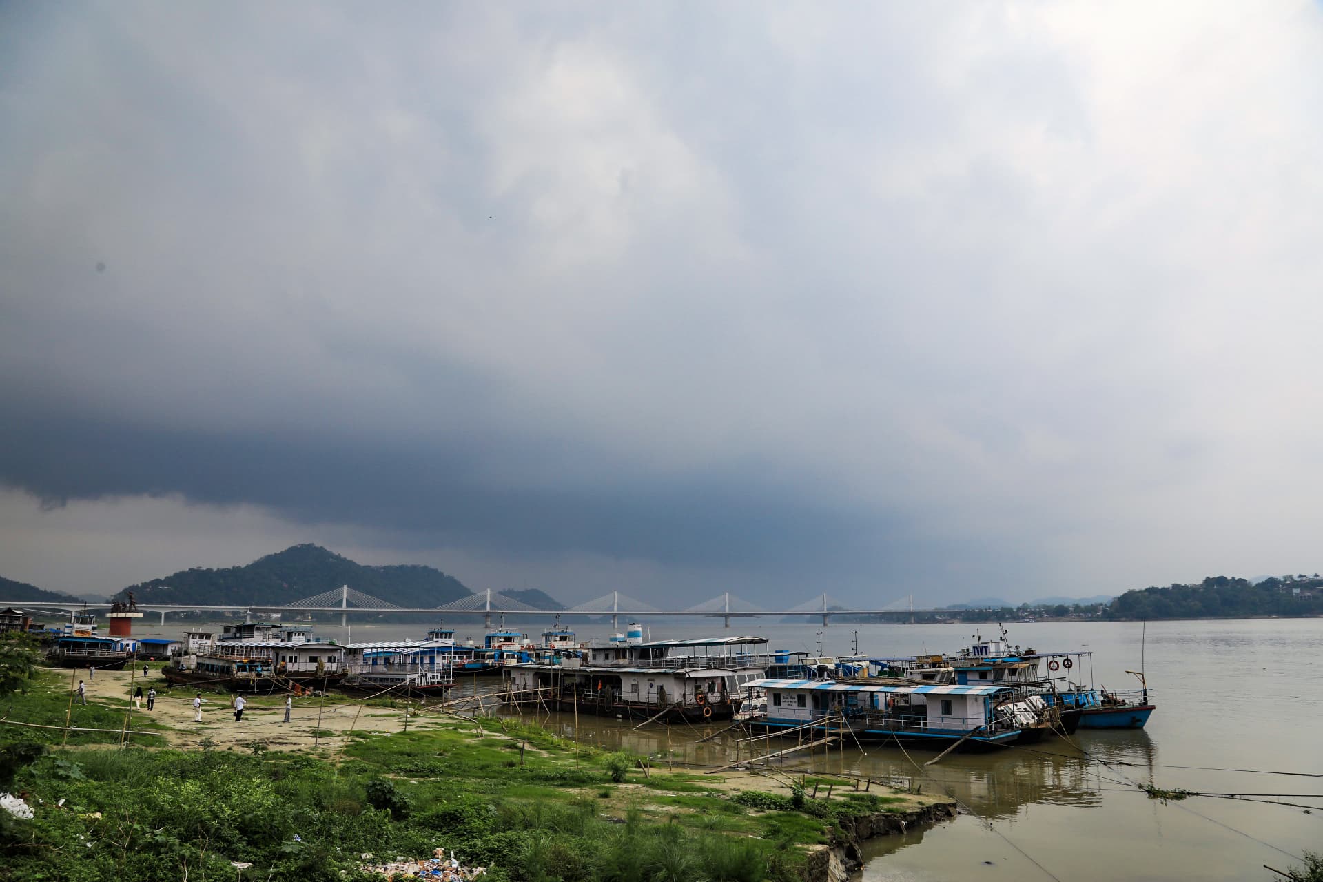 Guwahati: A view of the banks of the Brahmaputra River as dark rain clouds loom over the city skyline, in Guwahati on Sunday, April 26, 2026. (Photo: IANS)