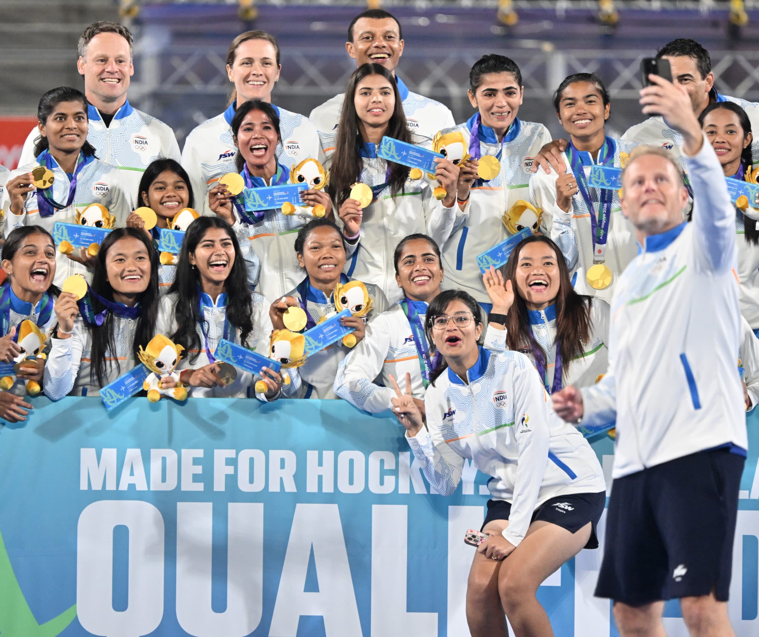 Kakamigahara: Indias womens hockey team pose for a selfie with their gold medals and a board celebrating their qualification for the Los Angeles 2028 Olympics during the medal ceremony at the Asian Games in Gifu, Japan, on Friday, October 2, 2026. (Photo: IANS/Biplab Banerjee)