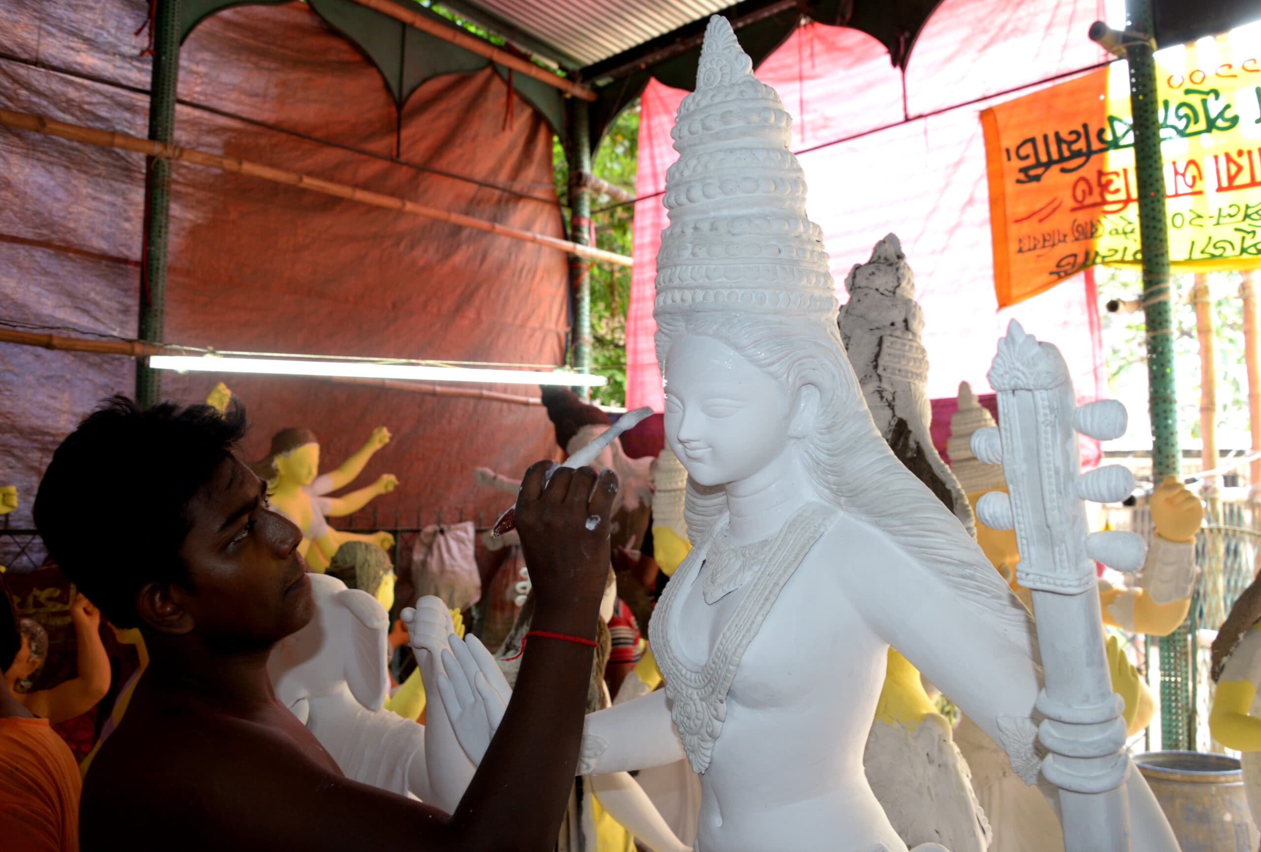 (181003) -- DHAKA, Oct. 3, 2018 (Xinhua) -- An artisan gives final touches to a clay idol of Hindu warrior goddess Durga before the upcoming Durga Festival at a workshop in Dhaka, Bangladesh, on Oct. 2, 2018.  (Xinhua) (zhf)
