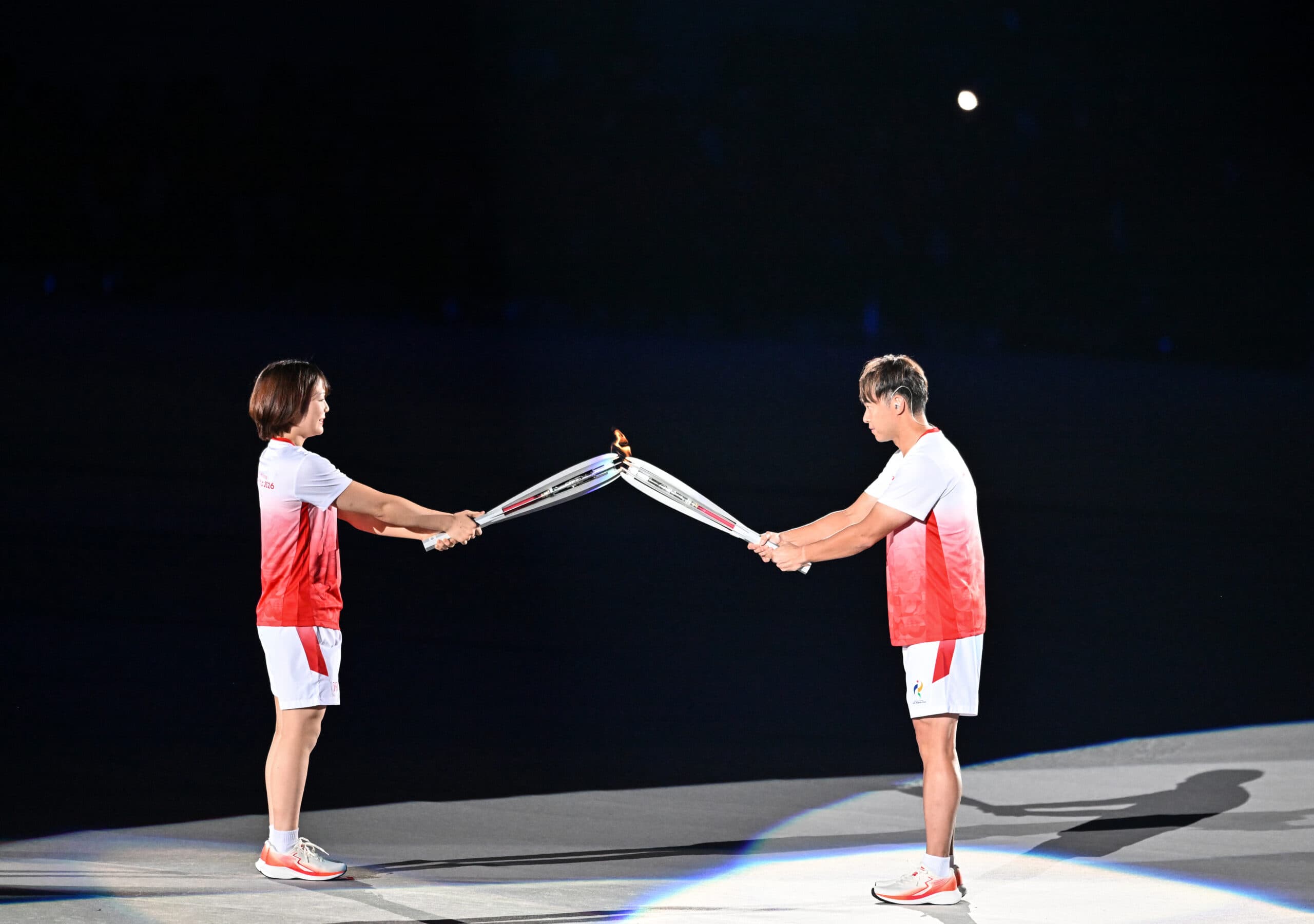 Nagoya: Japan's Akari Fujinami, left, and Kosuke Kitajima gesture with their torches before the lighting of the cauldron during the opening ceremony of the Asian Games 2026 in Nagoya, Japan, Saturday, September 19, 2026. (Photo: IANS/Biplab Banerjee)