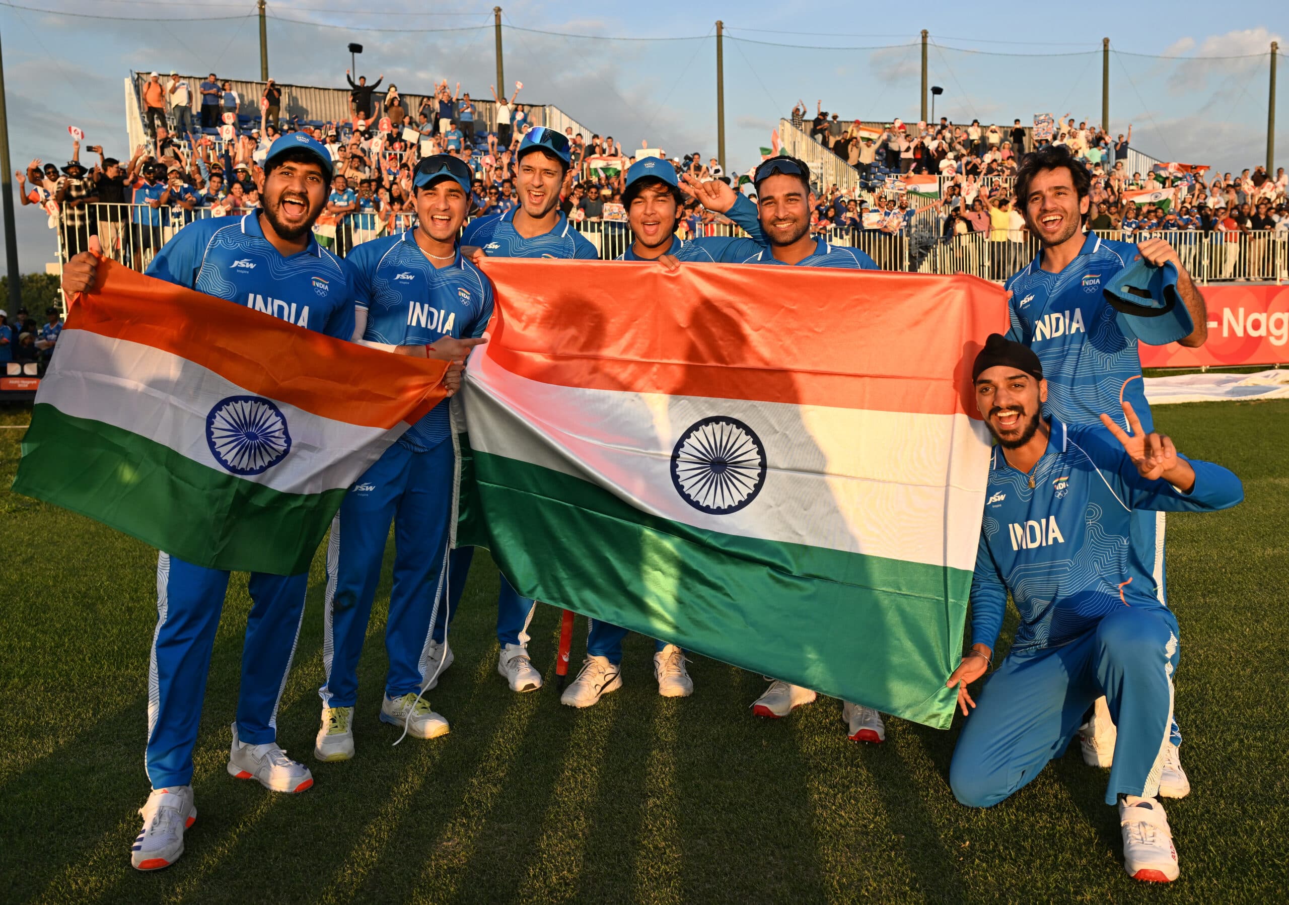 Nisshin: Indian players pose with the National Flag after winning gold in the men's T20I cricket final against Pakistan at the Asian Games 2026, at Korogi Sports Park in Nisshin, Japan, on Saturday, October 3, 2026. (Photo: IANS/Biplab Banerjee)