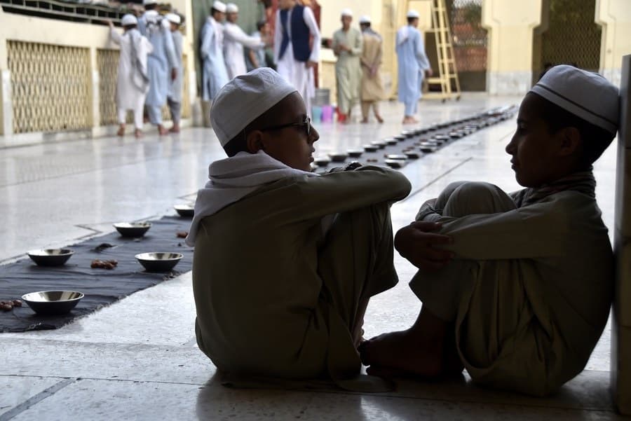 Children wait for Iftar, the fast breaking meal, at a mosque during the holy month of Ramadan in northwest Pakistan's Peshawar on April 3, 2022. (Photo by Saeed Ahmad/Xinhua/IANS)