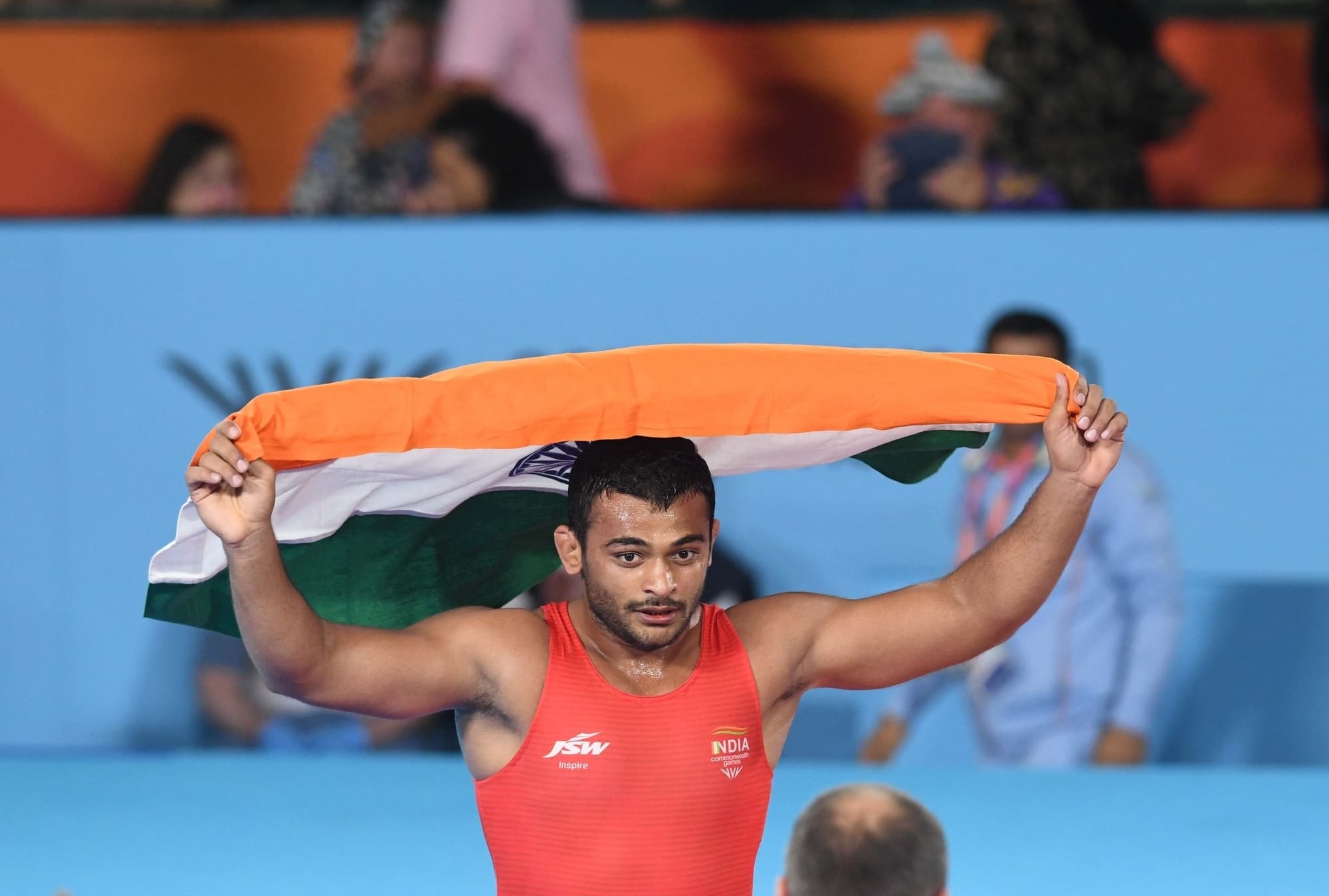 Birmingham:India's Deepak Punia hold Indian flag after winning against Pakistan's Muhammed Inam in the final of the Men's freestyle 86kg category event in the Commonwealth games in Birmingham, on Friday August 05, 2022.(Photo: Subir Halder/IANS)