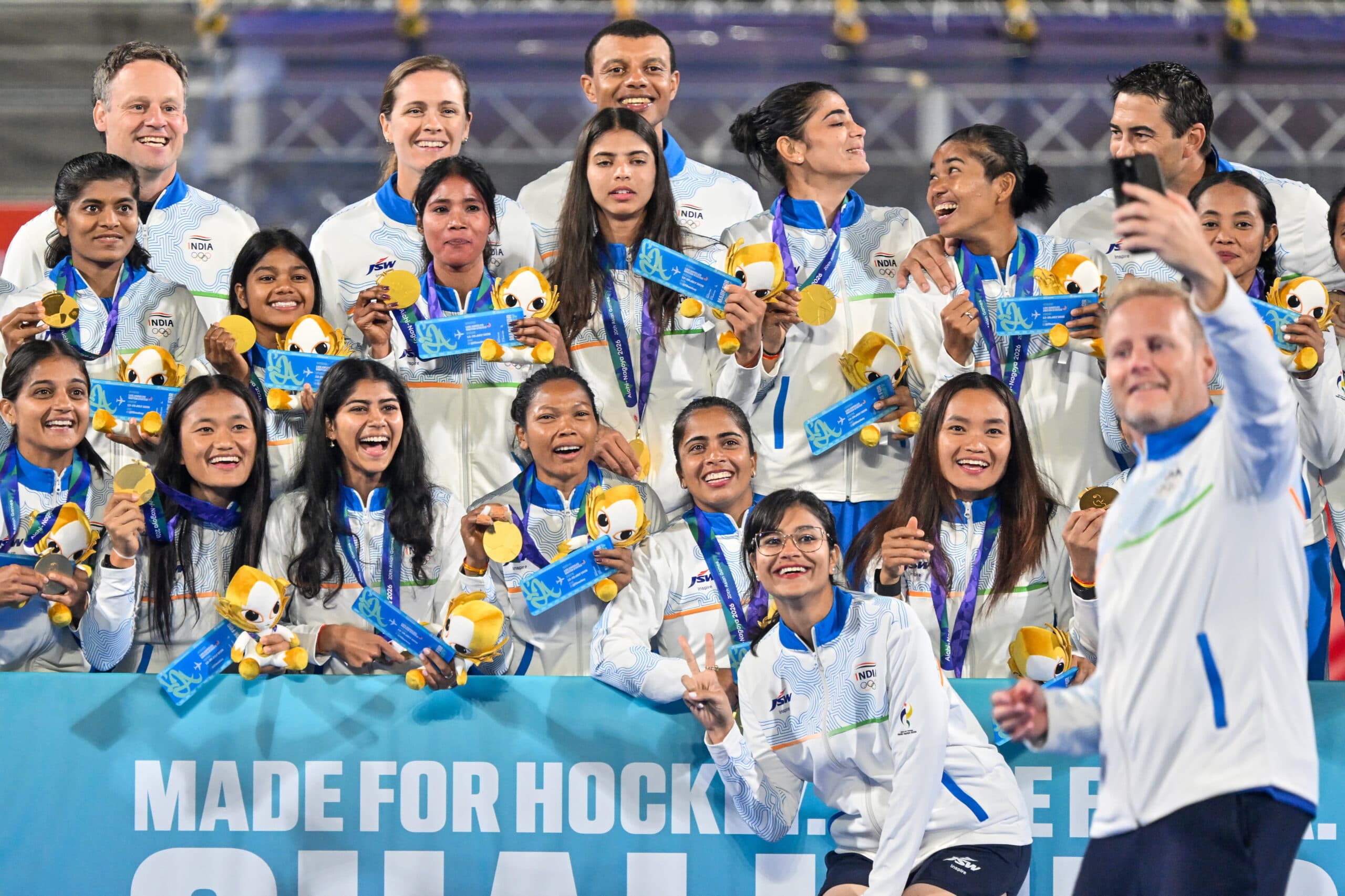 Kakamigahara: Indias womens hockey team pose for a selfie with their gold medals and a board celebrating their qualification for the Los Angeles 2028 Olympics during the medal ceremony at the Asian Games in Gifu, Japan, on Friday, October 2, 2026. (Photo: IANS/Biplab Banerjee)